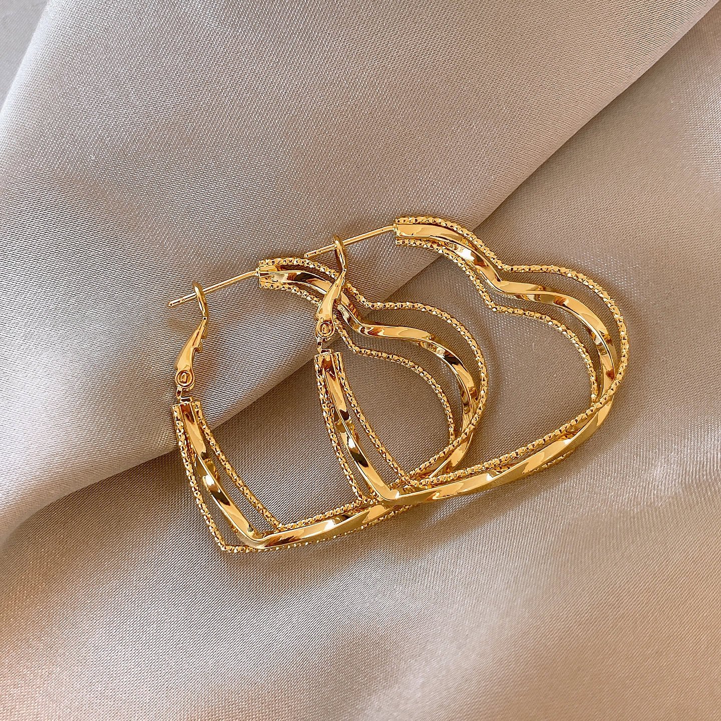 New multi-layered twisted heart-shaped large hoop earrings for women niche light luxury elegant versatile drop earrings.